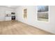Living room with bright light, hardwood floors, kitchen, and nature views at 4410 Ross Estates Ct, Snellville, GA 30039