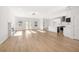 Spacious open-concept living area with hardwood floors, fireplace, and direct access to modern kitchen at 4410 Ross Estates Ct, Snellville, GA 30039