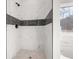 Walk-in shower featuring tile surround, modern fixtures and a shower niche at 4410 Ross Estates Ct, Snellville, GA 30039