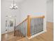 Bright foyer with wood stairs, black metal railings, hardwood floors, and natural light from front door at 4410 Ross Estates Ct, Snellville, GA 30039