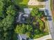 House featuring driveway, mature trees, landscaping, and charming curb appeal at 5923 Rosie Se Ln, Mableton, GA 30126