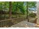 Inviting wooden deck offers a serene view of the lush, wooded backyard at 5923 Rosie Se Ln, Mableton, GA 30126