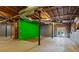 Unfinished basement featuring exposed ceiling, concrete walls, and access to the backyard at 5923 Rosie Se Ln, Mableton, GA 30126