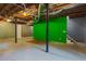Unfinished basement includes exposed supports and a green wall at 5923 Rosie Se Ln, Mableton, GA 30126