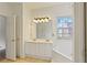 Bathroom with double sinks, large mirror, corner tub, and tile flooring at 5923 Rosie Se Ln, Mableton, GA 30126