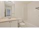 Well-lit bathroom with a single sink vanity, toilet, and a tub with shower at 5923 Rosie Se Ln, Mableton, GA 30126