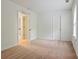 Neutral carpeted bedroom shows an opened door, and a window for plenty of light at 5923 Rosie Se Ln, Mableton, GA 30126