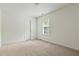 Carpeted bedroom with natural light from window, door, and neutral color palette at 5923 Rosie Se Ln, Mableton, GA 30126