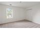 Carpeted bedroom with a double closet and a window at 5923 Rosie Se Ln, Mableton, GA 30126