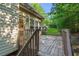 Exterior wooden deck and siding, looking out to a green, landscaped yard at 5923 Rosie Se Ln, Mableton, GA 30126