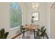 Bright dining room featuring a large window, modern chandelier, and stylish table setting at 5923 Rosie Se Ln, Mableton, GA 30126