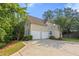 Home featuring an attached two-car garage, driveway and manicured lawn at 5923 Rosie Se Ln, Mableton, GA 30126