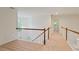 Upstairs hallway features wood railings and a view of a chandelier at 5923 Rosie Se Ln, Mableton, GA 30126
