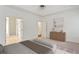Bright main bedroom featuring a tray ceiling, neutral paint, and an en suite bathroom at 5923 Rosie Se Ln, Mableton, GA 30126