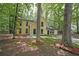 Charming yellow two-story home surrounded by mature trees and landscaping at 7156 Whitfield Drive Dr, Riverdale, GA 30296