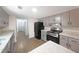 The updated kitchen features granite countertops, stainless steel appliances, and wood floors at 7156 Whitfield Drive Dr, Riverdale, GA 30296