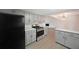 This kitchen features granite countertops, stainless steel appliances, gray cabinets, and wood floors at 7156 Whitfield Drive Dr, Riverdale, GA 30296