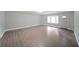 Bright, open living room with hardwood floors and large bay window at 7156 Whitfield Drive Dr, Riverdale, GA 30296