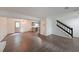 Open-concept living space featuring hardwood floors, stairs, and a modern chandelier at 7156 Whitfield Drive Dr, Riverdale, GA 30296