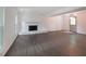 Spacious living room with stone fireplace, large windows, and hardwood floors at 7156 Whitfield Drive Dr, Riverdale, GA 30296