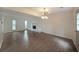 Open-concept living room with fireplace, modern light fixture, and large windows at 7156 Whitfield Drive Dr, Riverdale, GA 30296