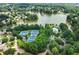 Aerial view showcasing lakefront community amenities including tennis courts and a pool at 1115 Ballington Dr, Cumming, GA 30041