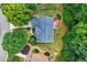 Aerial view of a home featuring a well-maintained yard, large deck, and mature trees at 1115 Ballington Dr, Cumming, GA 30041