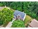 Aerial view of a home featuring mature trees, a well-manicured lawn, and traditional architecture at 1115 Ballington Dr, Cumming, GA 30041