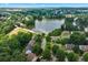 Community aerial view showcasing a serene lake and surrounding homes nestled among lush greenery at 1115 Ballington Dr, Cumming, GA 30041