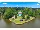 Stunning aerial view of the property on a private island with a pool, gazebo and meticulously kept grounds at 1115 Ballington Dr, Cumming, GA 30041
