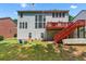 Spacious backyard with lush green grass, patio area, and multi-level deck attached to house at 1115 Ballington Dr, Cumming, GA 30041