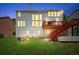 Backyard at dusk featuring well-maintained lawn, patio seating, and home exterior at 1115 Ballington Dr, Cumming, GA 30041
