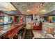 In-home bar featuring wood finishes, a full bar, a tv, and quirky decorations at 1115 Ballington Dr, Cumming, GA 30041