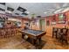 Finished basement featuring a pool table, bar, and rustic decor for entertaining at 1115 Ballington Dr, Cumming, GA 30041