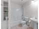 Clean, all-white bathroom featuring a shower-tub combo and pedestal sink at 1115 Ballington Dr, Cumming, GA 30041