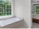 Bright primary bathroom with soaking tub and natural light at 1115 Ballington Dr, Cumming, GA 30041