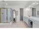 Bright bathroom with double sink vanity, a gold framed shower, and a decorative floor mirror at 1115 Ballington Dr, Cumming, GA 30041