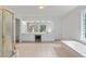 Spacious bathroom features a dual sink vanity, tiled floor, and a soaking tub at 1115 Ballington Dr, Cumming, GA 30041