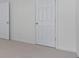Bedroom with neutral carpet with doors in the foreground at 1115 Ballington Dr, Cumming, GA 30041