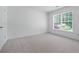 Bright bedroom featuring neutral carpet, a large window and ample natural light at 1115 Ballington Dr, Cumming, GA 30041