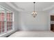 Elegant dining area featuring detailed molding, chandelier, and large windows at 1115 Ballington Dr, Cumming, GA 30041