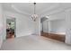 Spacious dining room featuring elegant chandelier, wainscoting, and open floor plan perfect for entertaining at 1115 Ballington Dr, Cumming, GA 30041