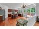 Open kitchen boasts cherry cabinets, central island, stainless appliances, and hardwood floors at 1115 Ballington Dr, Cumming, GA 30041