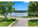 Scenic lake view featuring a charming bridge, lush greenery, and calm waters for a peaceful setting at 1115 Ballington Dr, Cumming, GA 30041