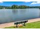 Beautiful lake view from a bench on the shore, perfect for relaxation and enjoying the scenery at 1115 Ballington Dr, Cumming, GA 30041