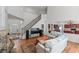 Open-concept living room with fireplace, staircase, and views into the kitchen, creating a spacious atmosphere at 1115 Ballington Dr, Cumming, GA 30041