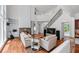 Bright and airy living room with hardwood floors, stone fireplace and staircase to second floor at 1115 Ballington Dr, Cumming, GA 30041