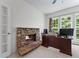 Office features a stone fireplace, neutral carpet, and natural light at 1115 Ballington Dr, Cumming, GA 30041