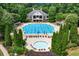 Aerial view of a large community pool with plenty of chairs, lush greenery, and a hot tub at 1115 Ballington Dr, Cumming, GA 30041