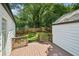 Backyard features a stained deck with wooden railings and a wooden fence surrounding a lush green yard at 2485 Hillside Ave, Decatur, GA 30032